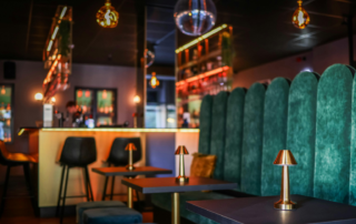 Upscale Nevada cannabis consumption lounge interior with velvet booth seating and bar